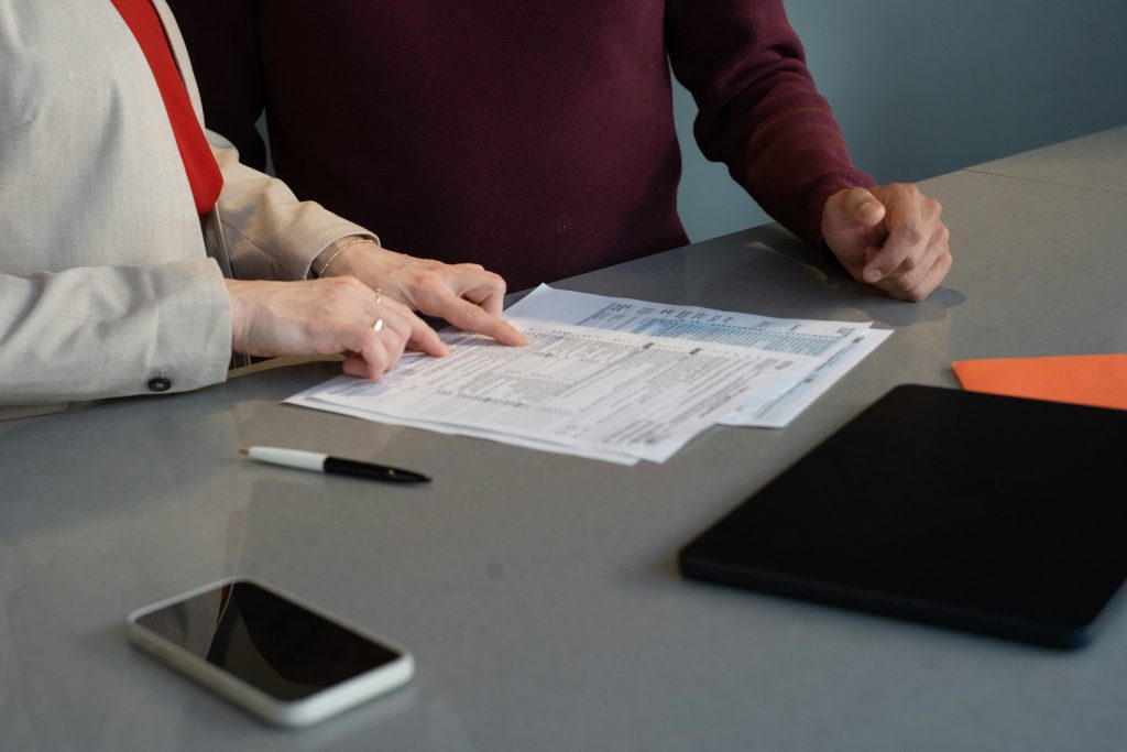 Two professionals reviewing tax documents at a conference table